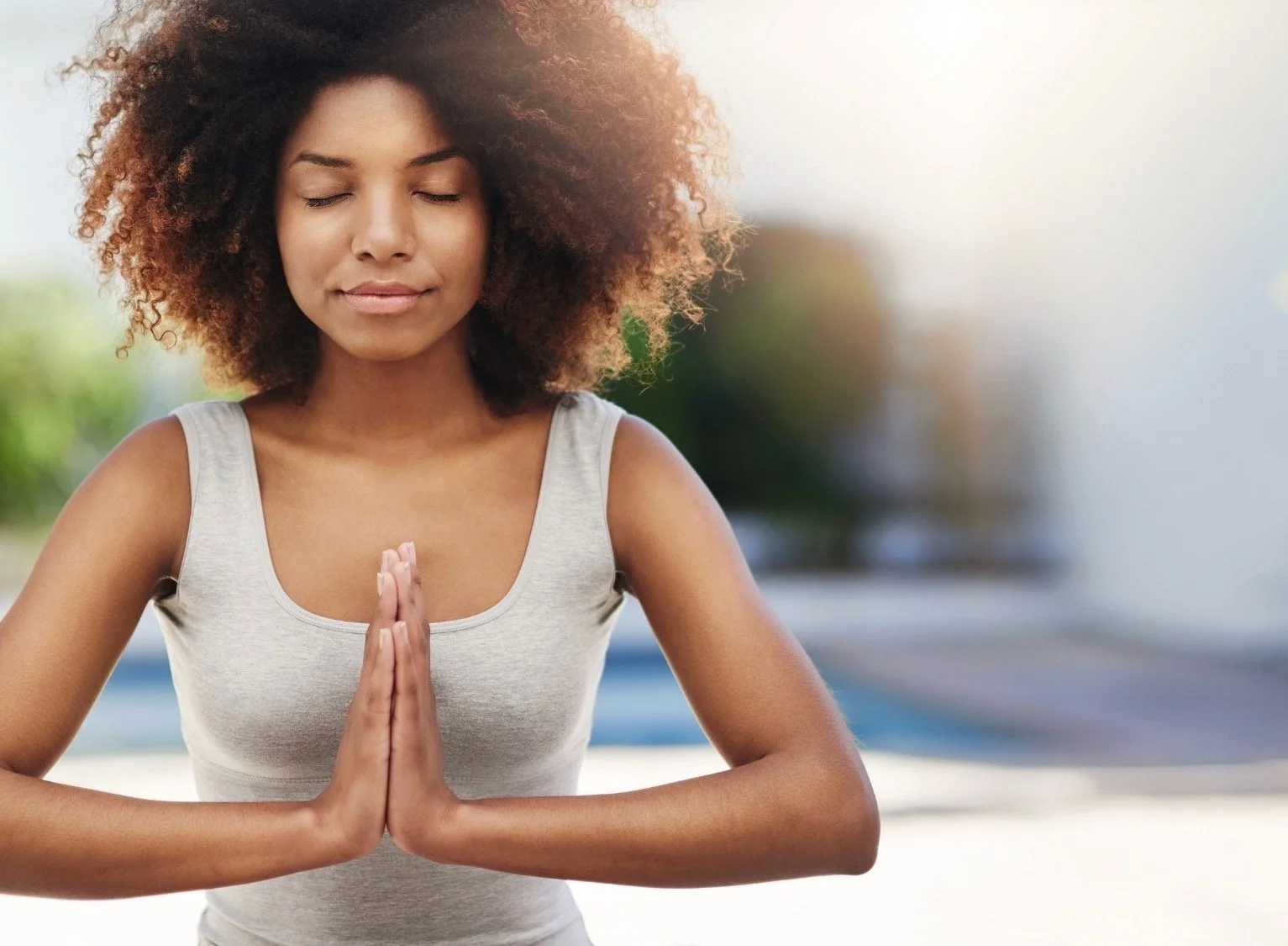 Woman practicing yoga meditation with hands in prayer position