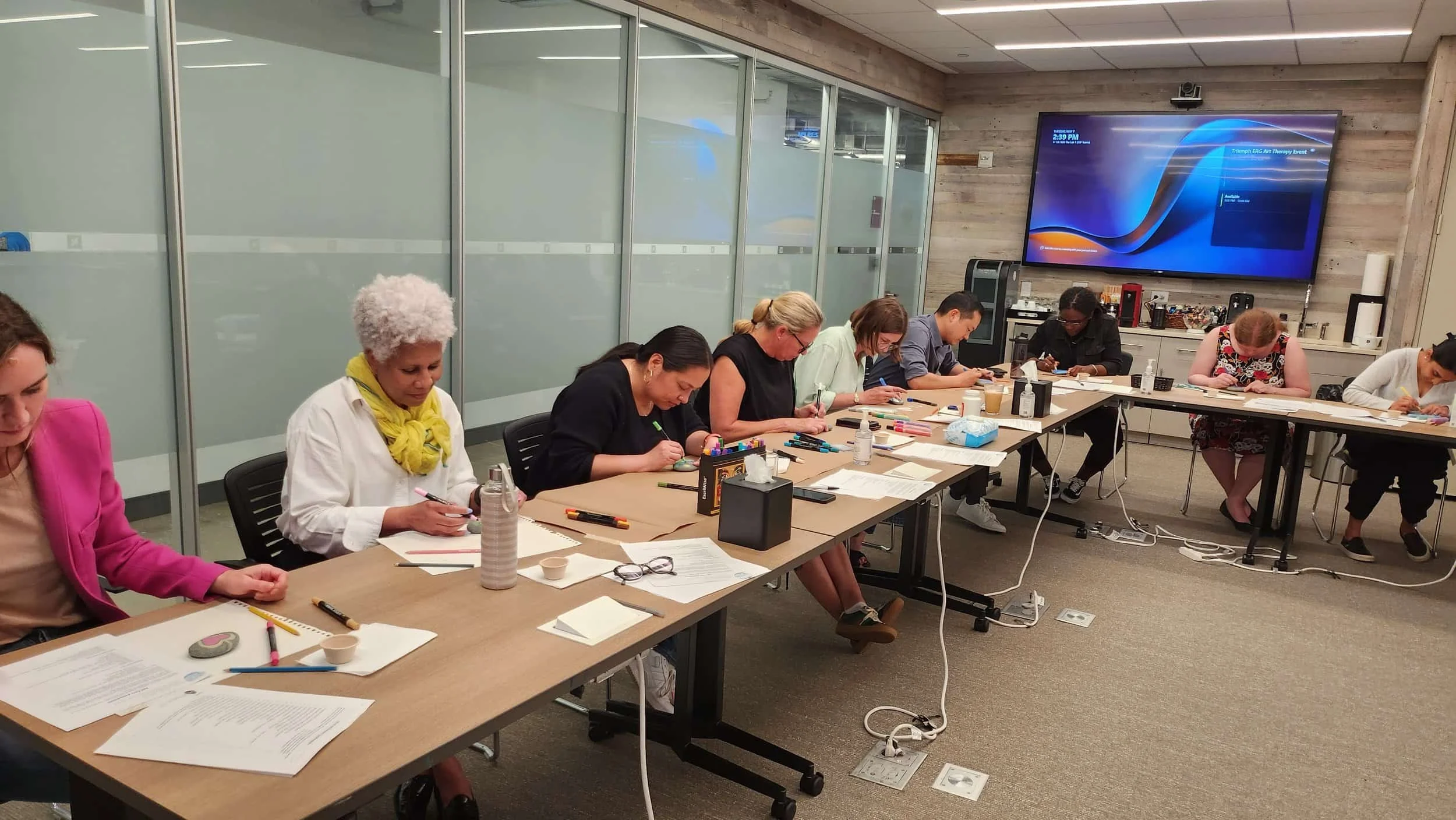 a company enjoying an art-based corporate wellness workshop in nyc led by julia kim creative arts therapy pllc