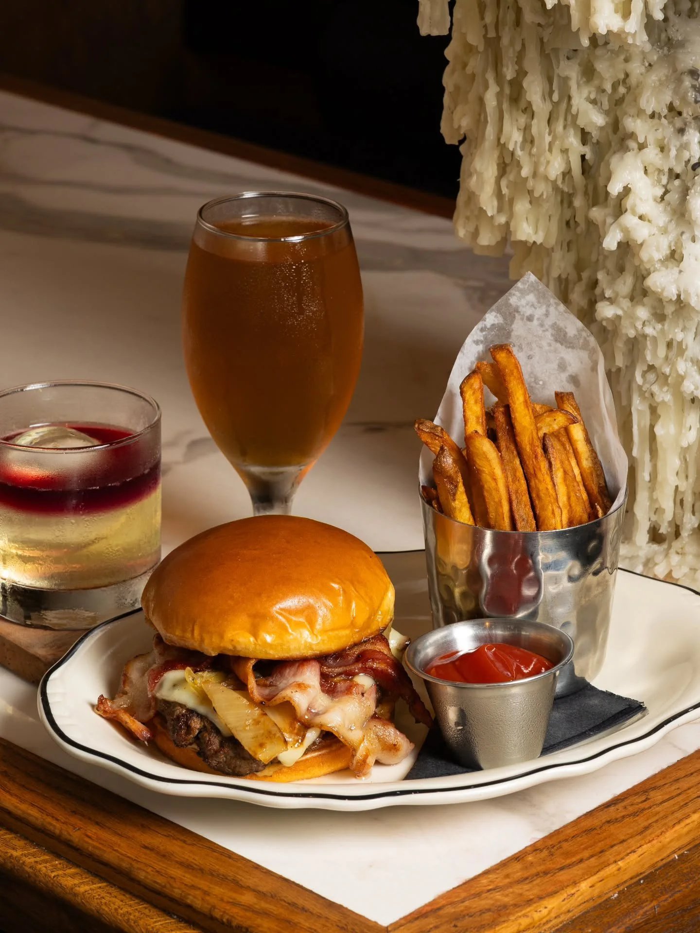 Rich bone marrow blended into juicy steak trimmings, finished with melted Swiss, caramelized onions, and applewood smoked bacon on a soft brioche bun. 🍔

Also available during Happy Hour daily from 4PM&ndash;6PM for only $17 with house-cut fries and
