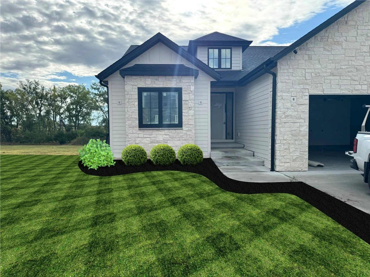Front view of a modern house exterior with stone and siding, featuring a neatly landscaped yard with hedges and a visible garage. A truck is parked on the driveway under a partly cloudy sky.