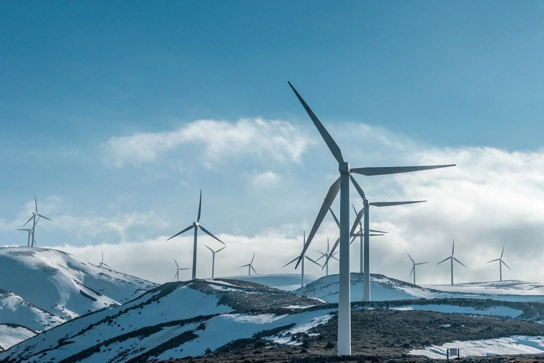Wind turbines on high remote ground reflecting Sea To Sky Energy Solutions' operations and development services in Wind Energy.