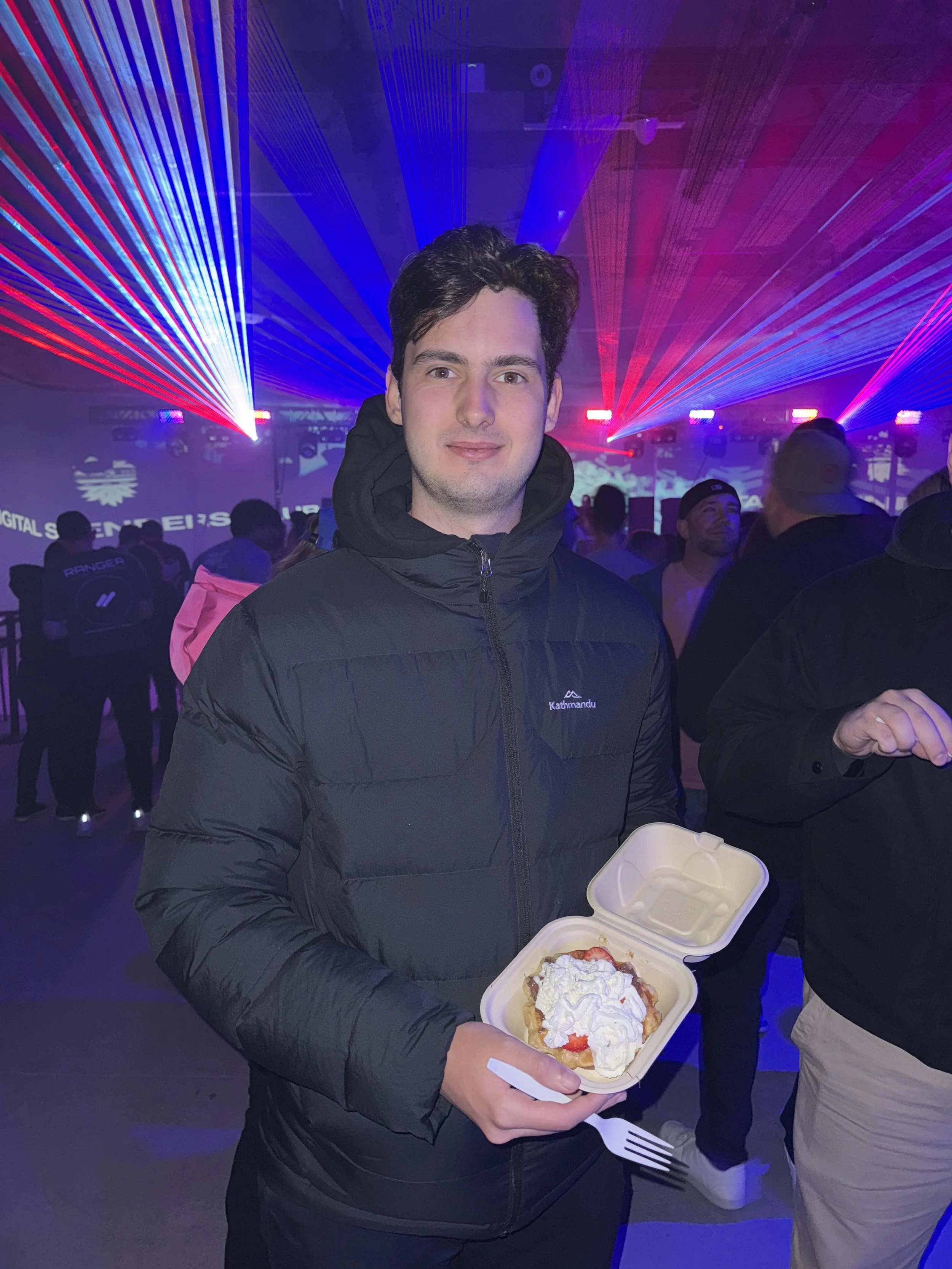 Tom's waffles at a corperate party. Person enjoying tom's event catering at a crypto rave