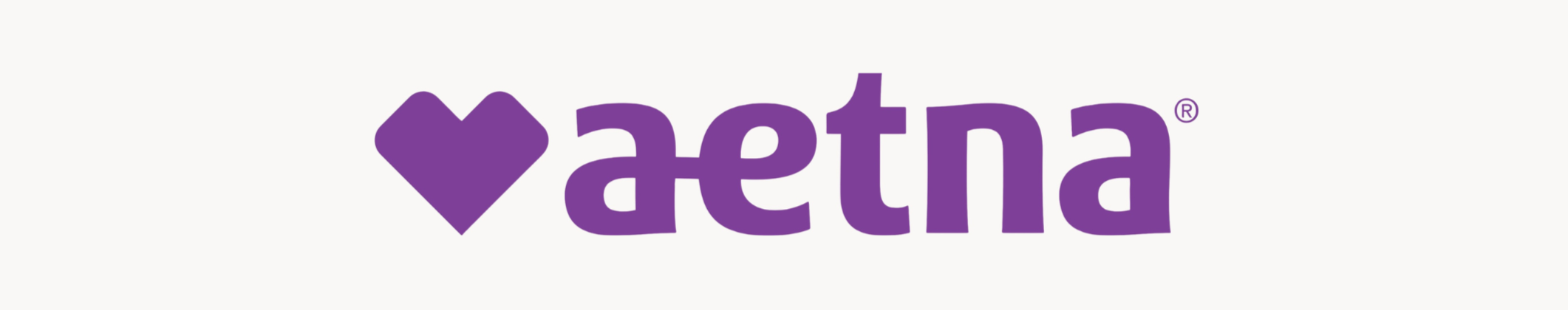 A purple heart symbol followed by the word "Aetna" in purple text.