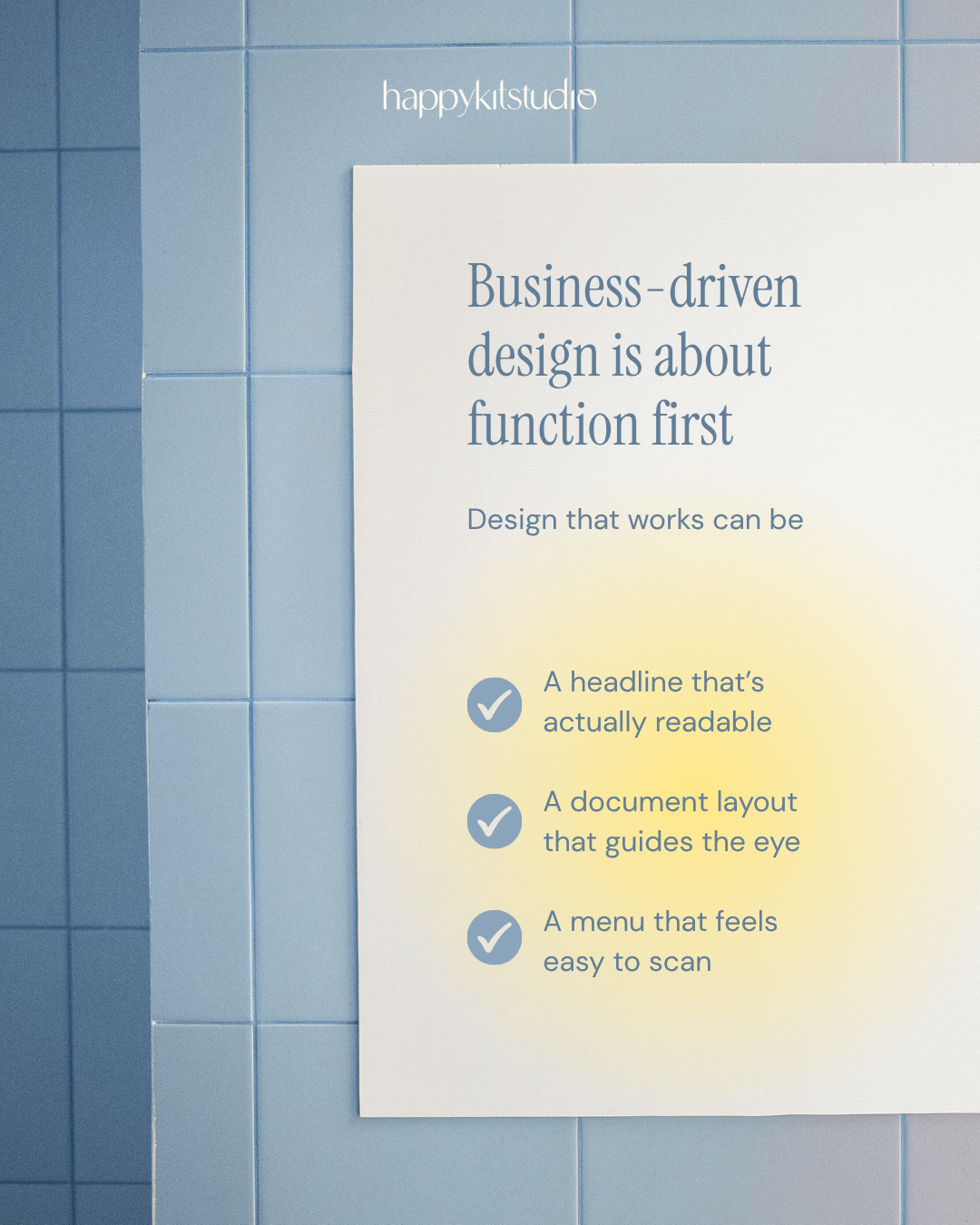 Sign with the message 'Business-driven design is about function first' and three checkmarks with related points, on a tiled wall.