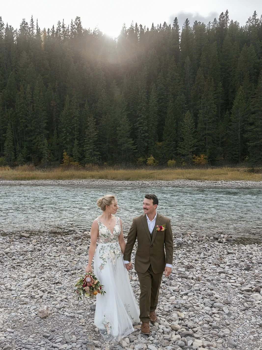 This October wedding had everything. A beautiful intimate riverside ceremony followed by a party with all of their crew, and we even had snow!

Photo: @findthewild.ca 
Hair + Makeup: @onlocationn 
Flowers: @willowflowerco 
Rentals: @mountaineventrent