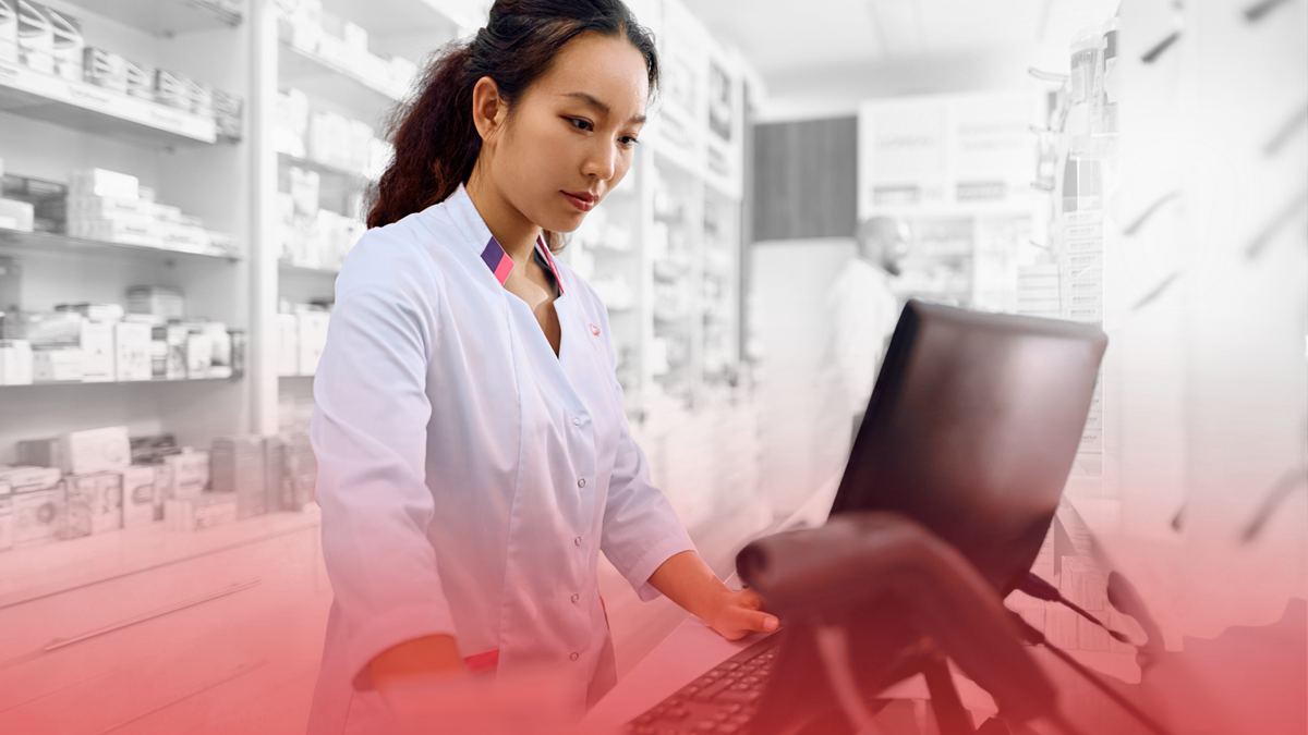 Pharmacy employee using retail ERP software to manage inventory and operations across multiple store locations