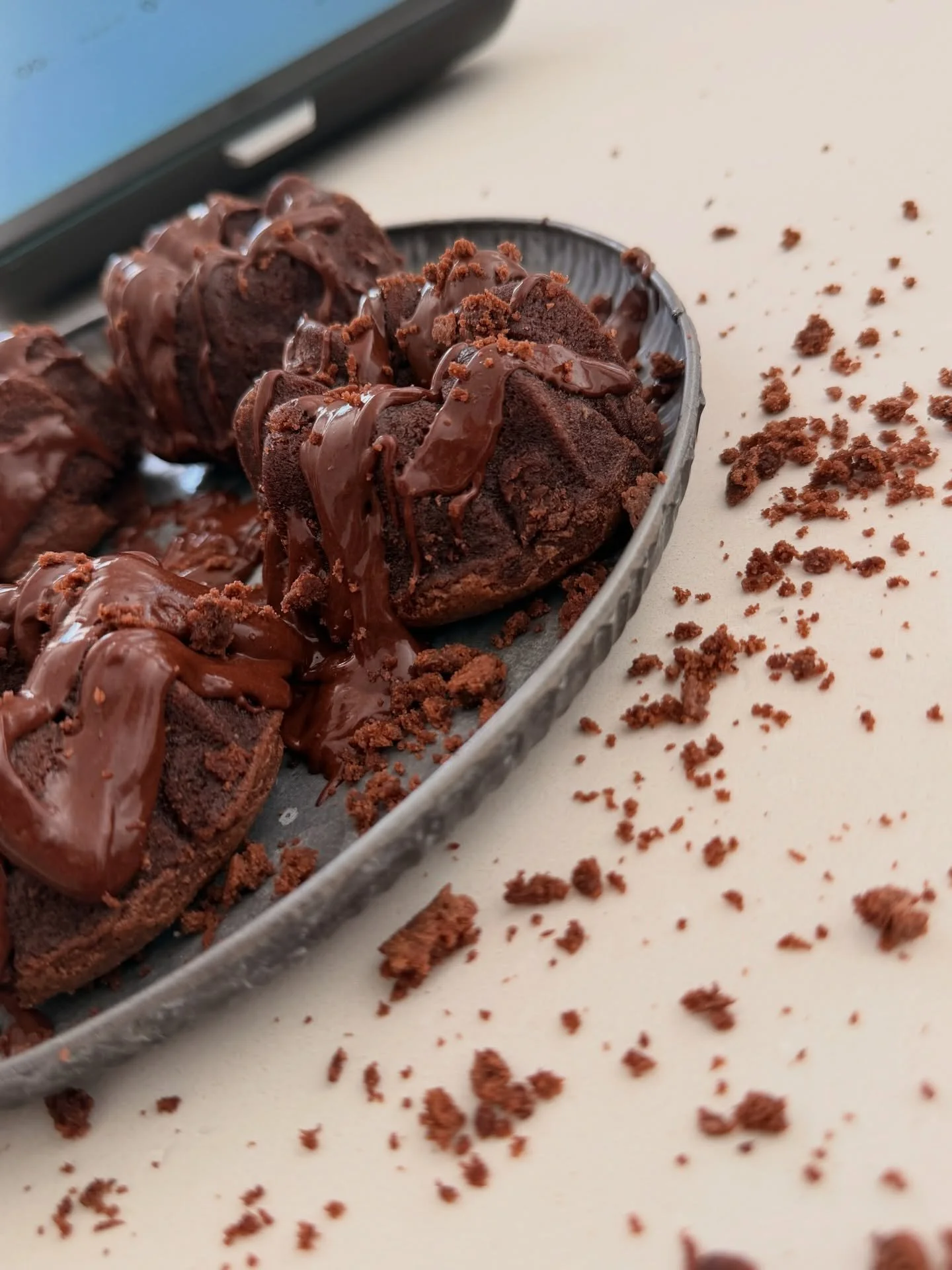 decadent chocolate desert crumbled off the plate onto the table