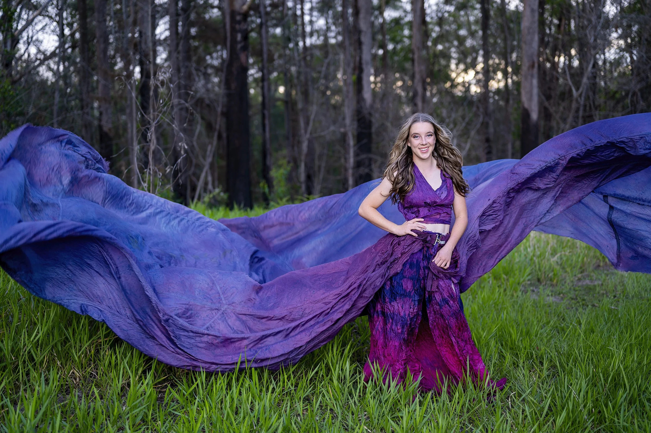 Click the girl in the forest wearing a purple dress to visit our photography page