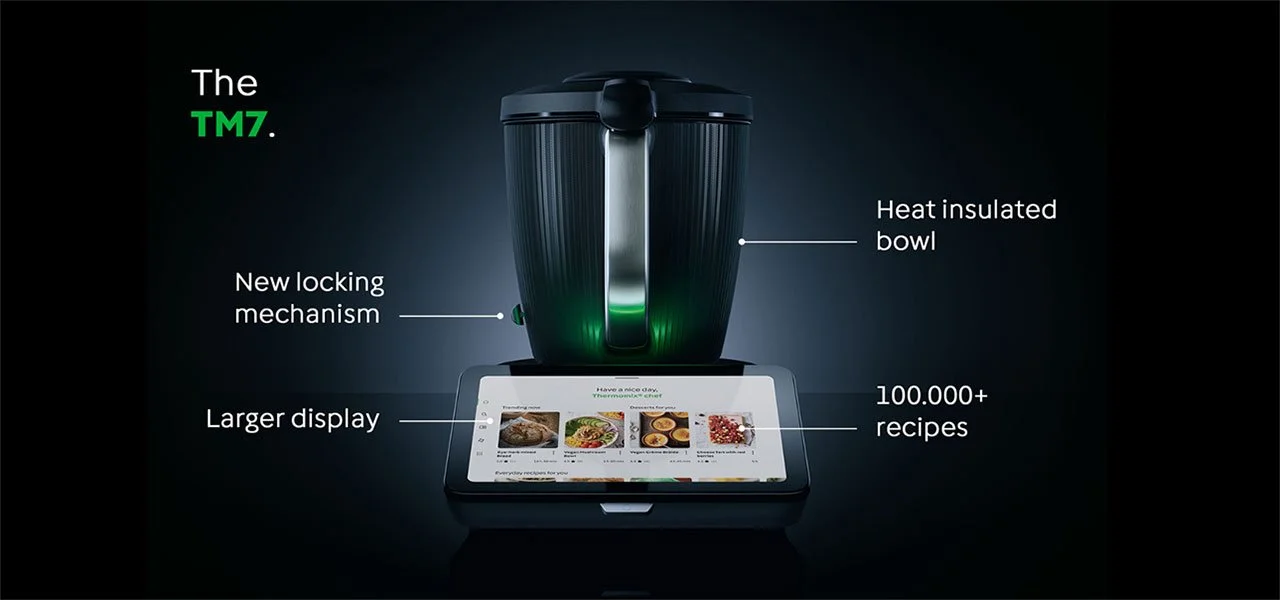 Thermomix on black backgroud with text saying: new locking mechanism, larger display, heat insulated bowl, 100.000+ recipes