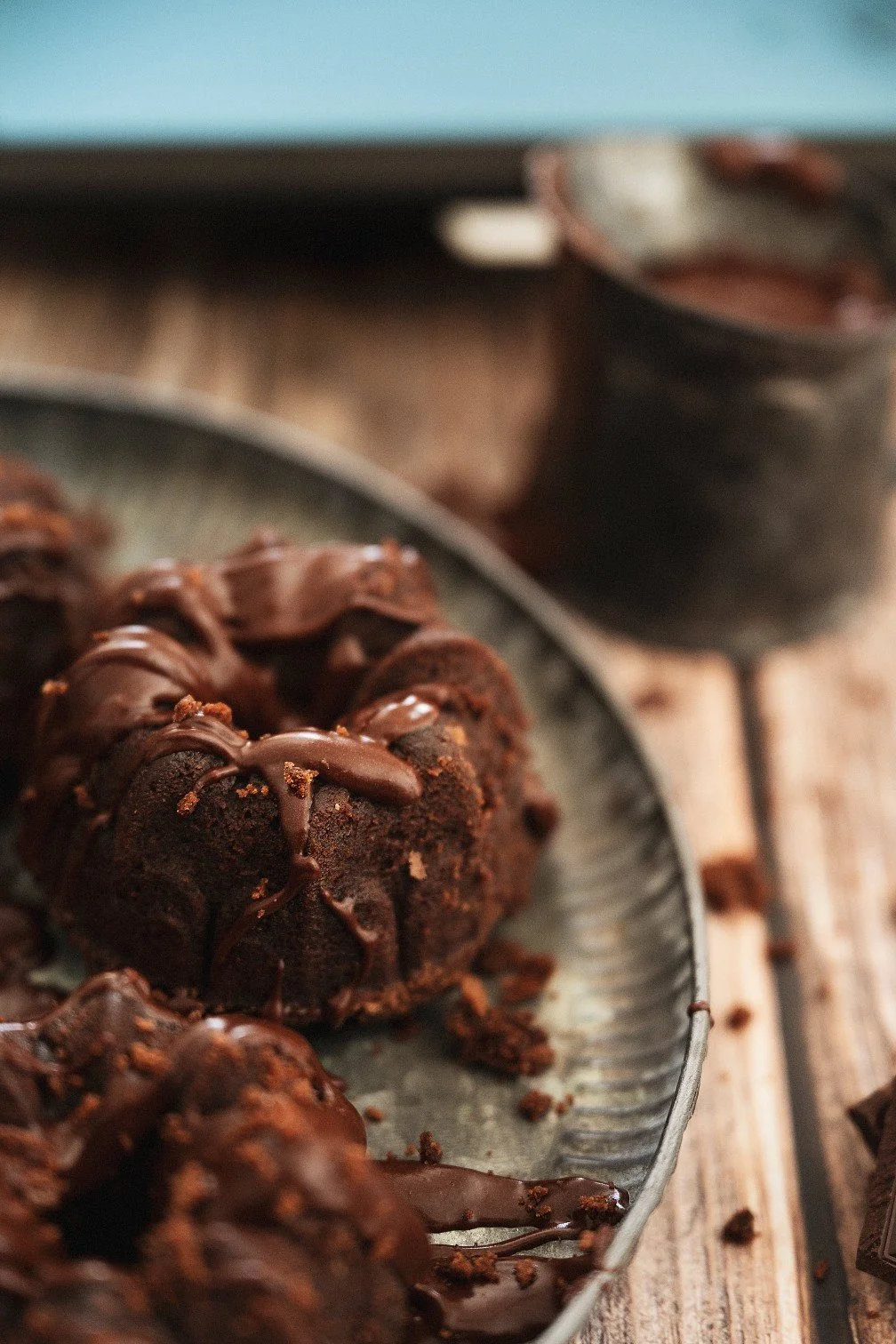 Chocolate cake drizzled with chocolate and crumb on a plate