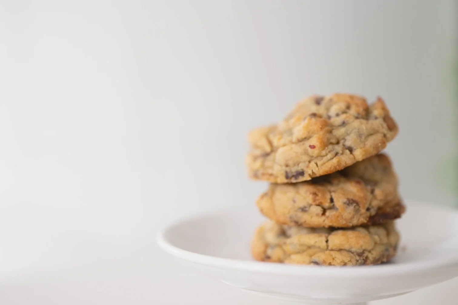 3 chunky cookies on a white plate