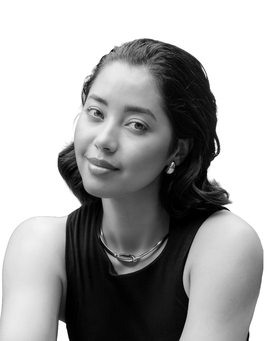Black and white portrait of a woman with shoulder-length dark hair, wearing a sleeveless top, earrings, and a necklace, with a neutral facial expression.