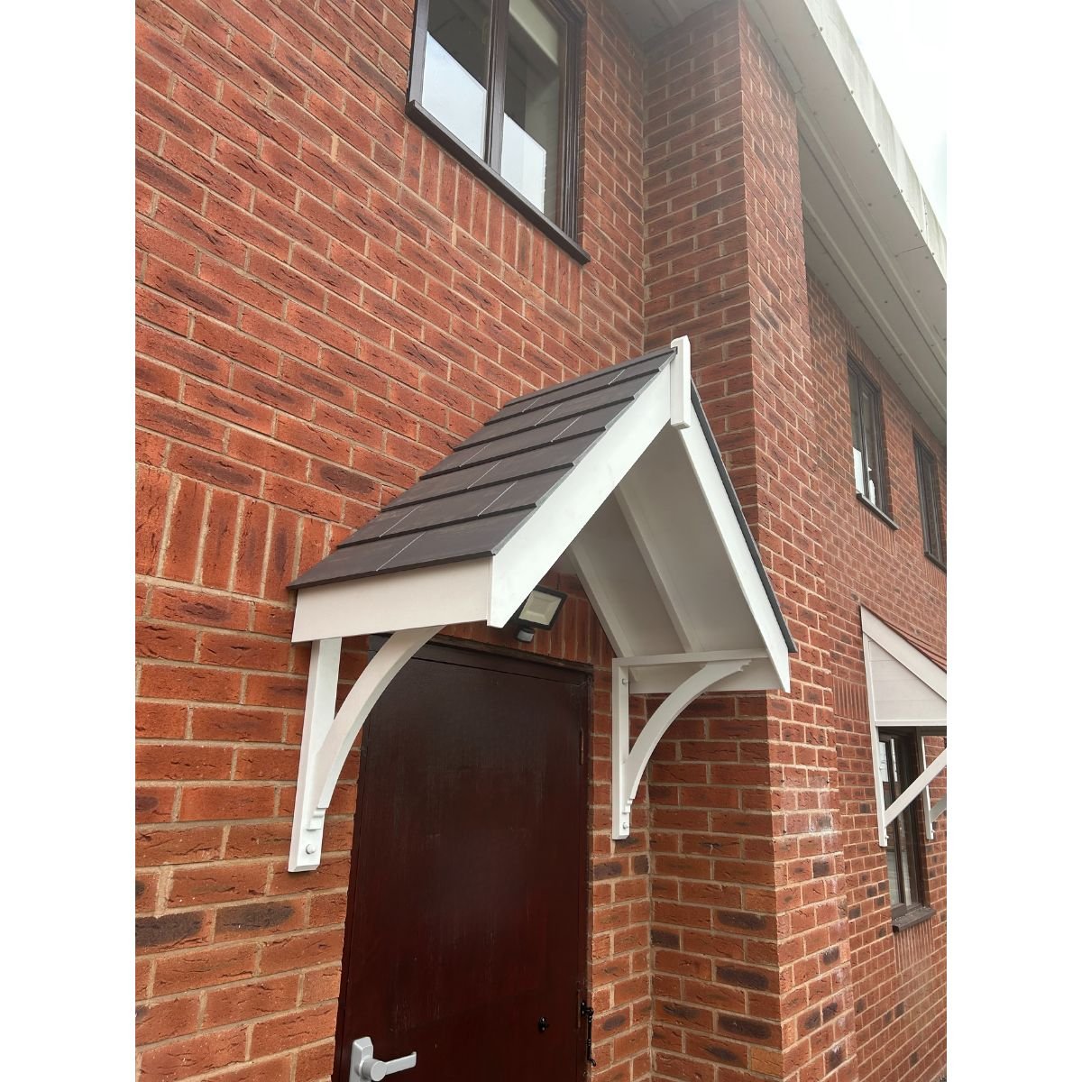 a door canopy without a truss on a brick wall