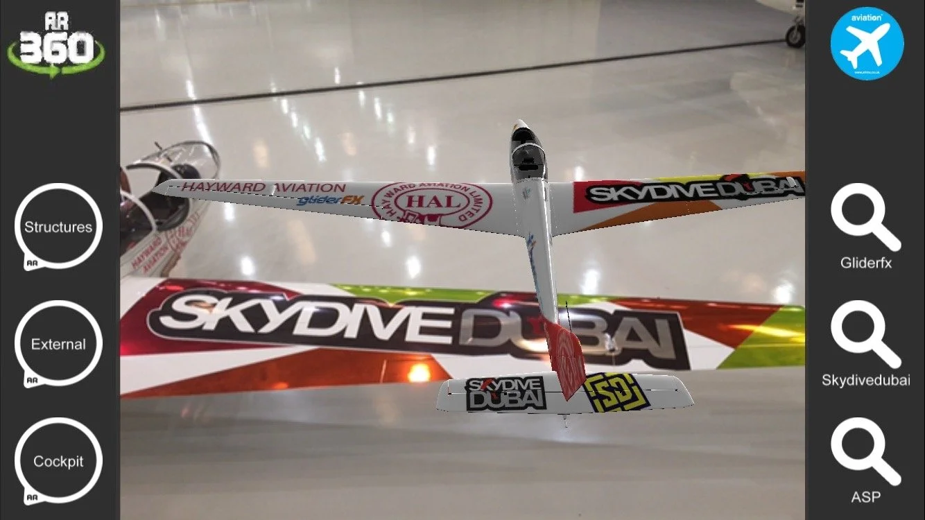 Scale model airplane with 'Skydive Dubai' logo displayed indoors on a shiny floor.