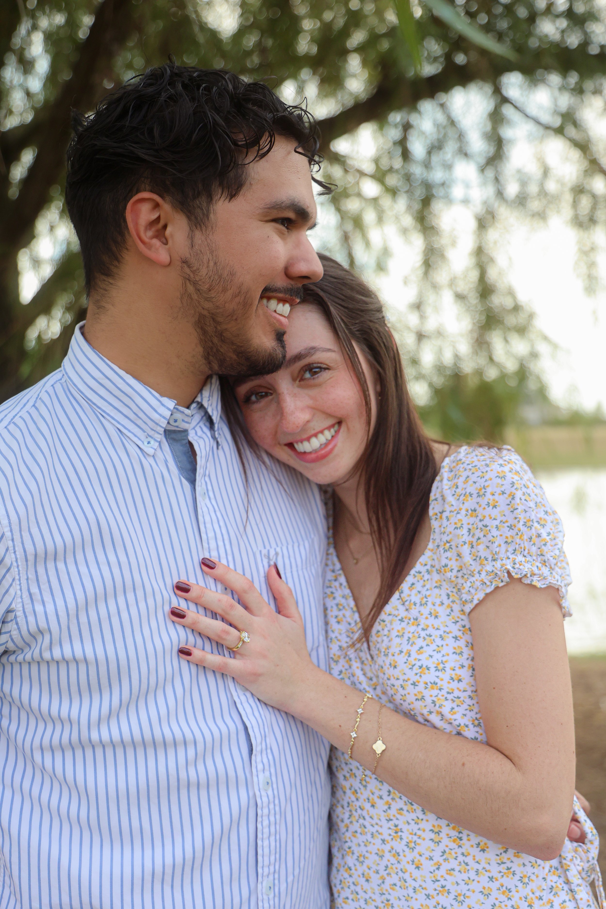 Couple hugs in the summer after proposal photography session in Carmel, Indiana captured by proposal photographer