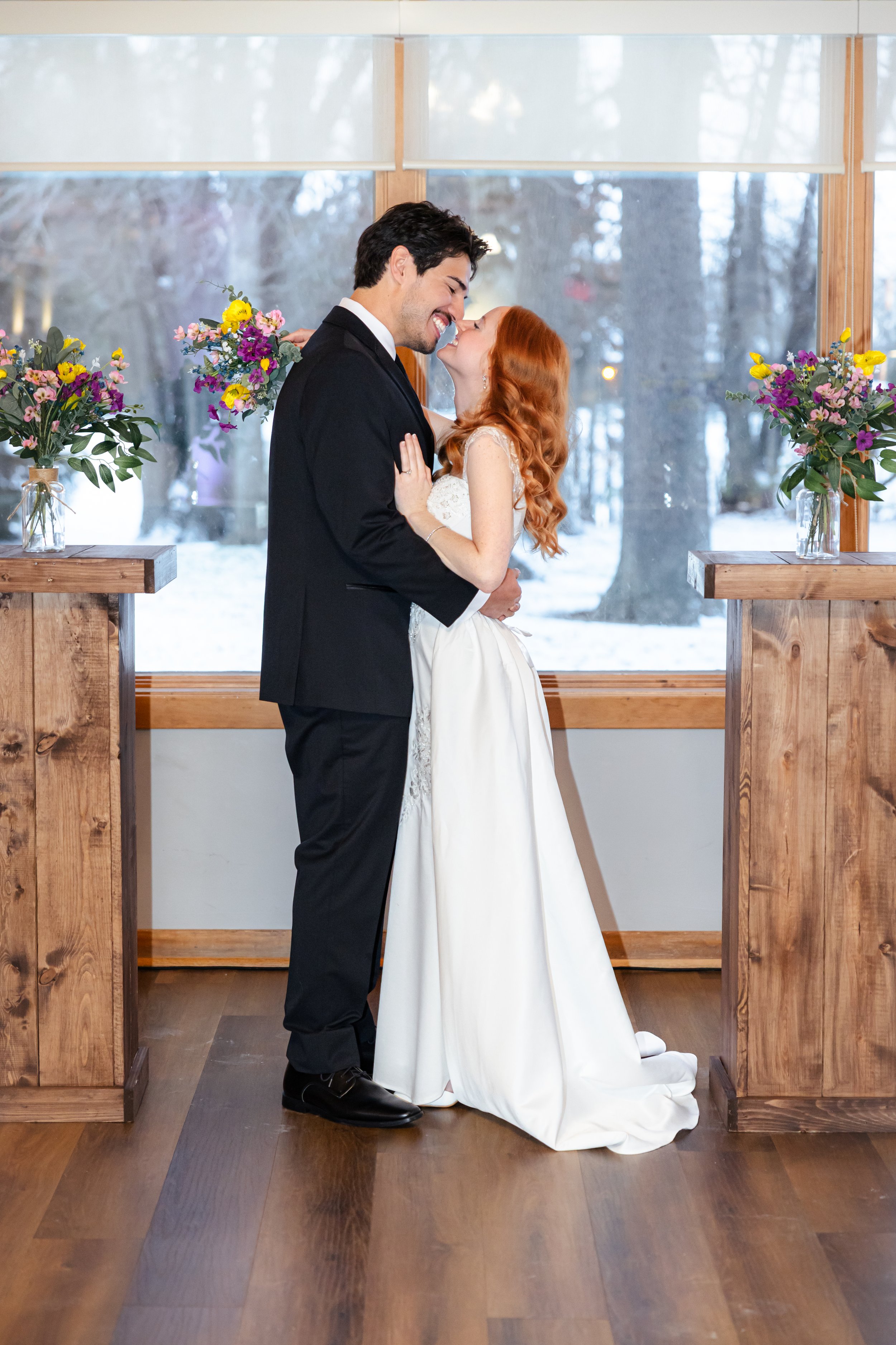 A bride and groom posing during couples portraits at winter wedding indoor ceremony captured by wedding photographer in Indianapolis