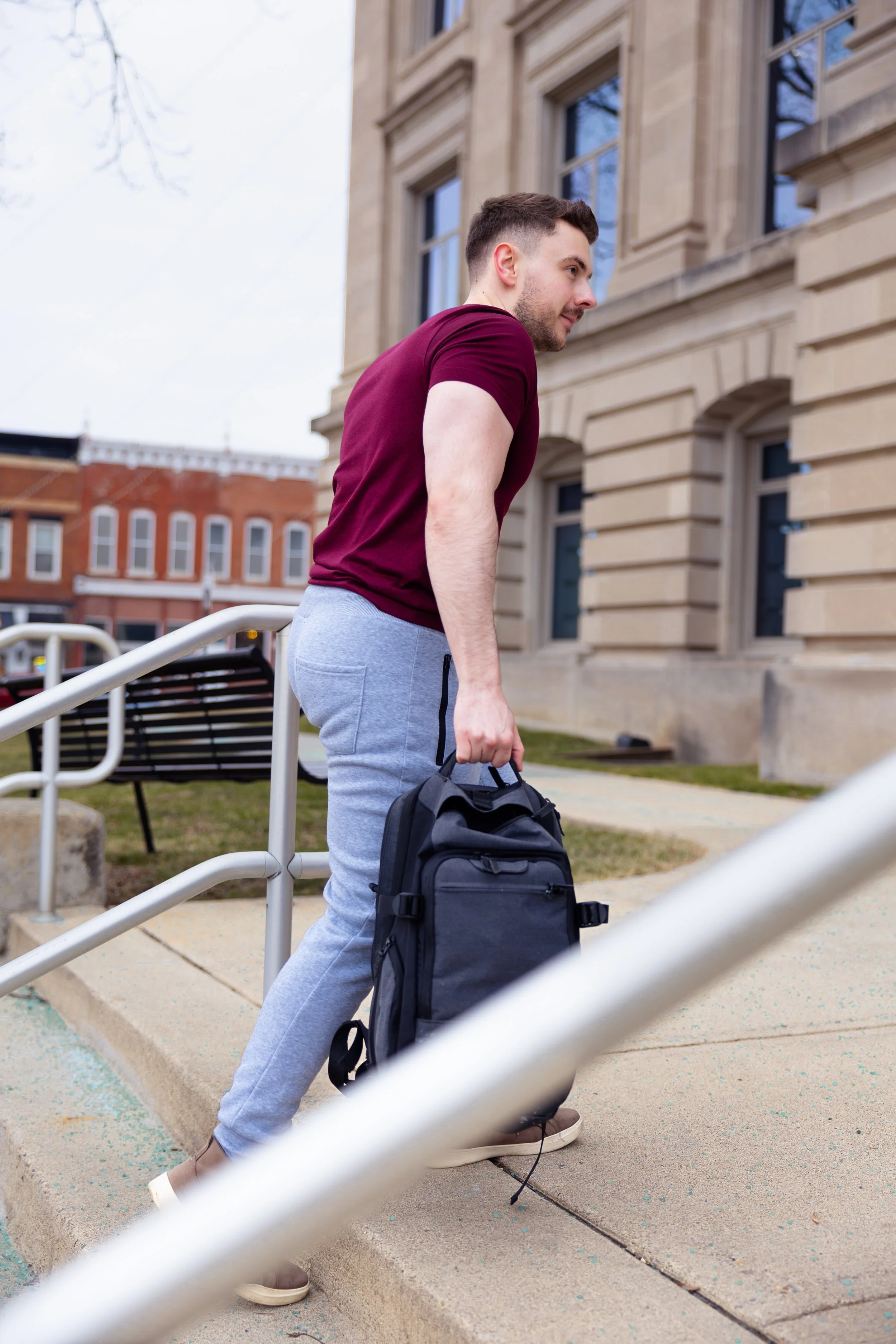 Indianapolis portrait session of a man walking upstairs in workout clothes