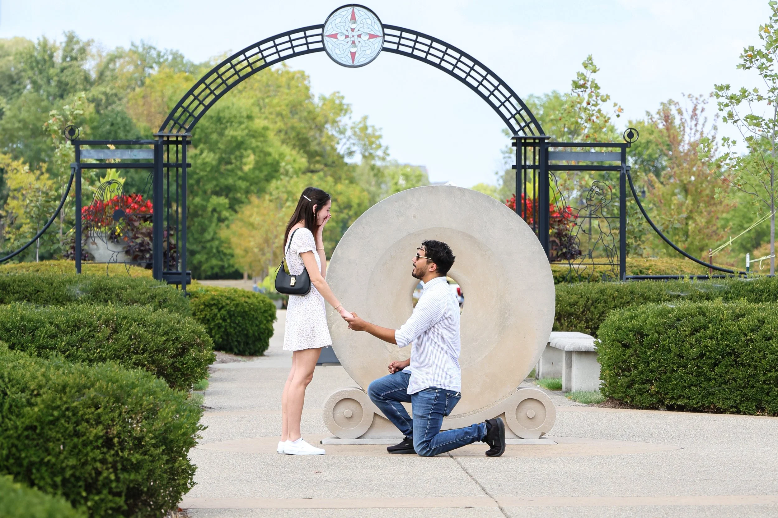 Man proposes to woman in the summer during proposal photography session in Carmel, Indiana at an outdoor park