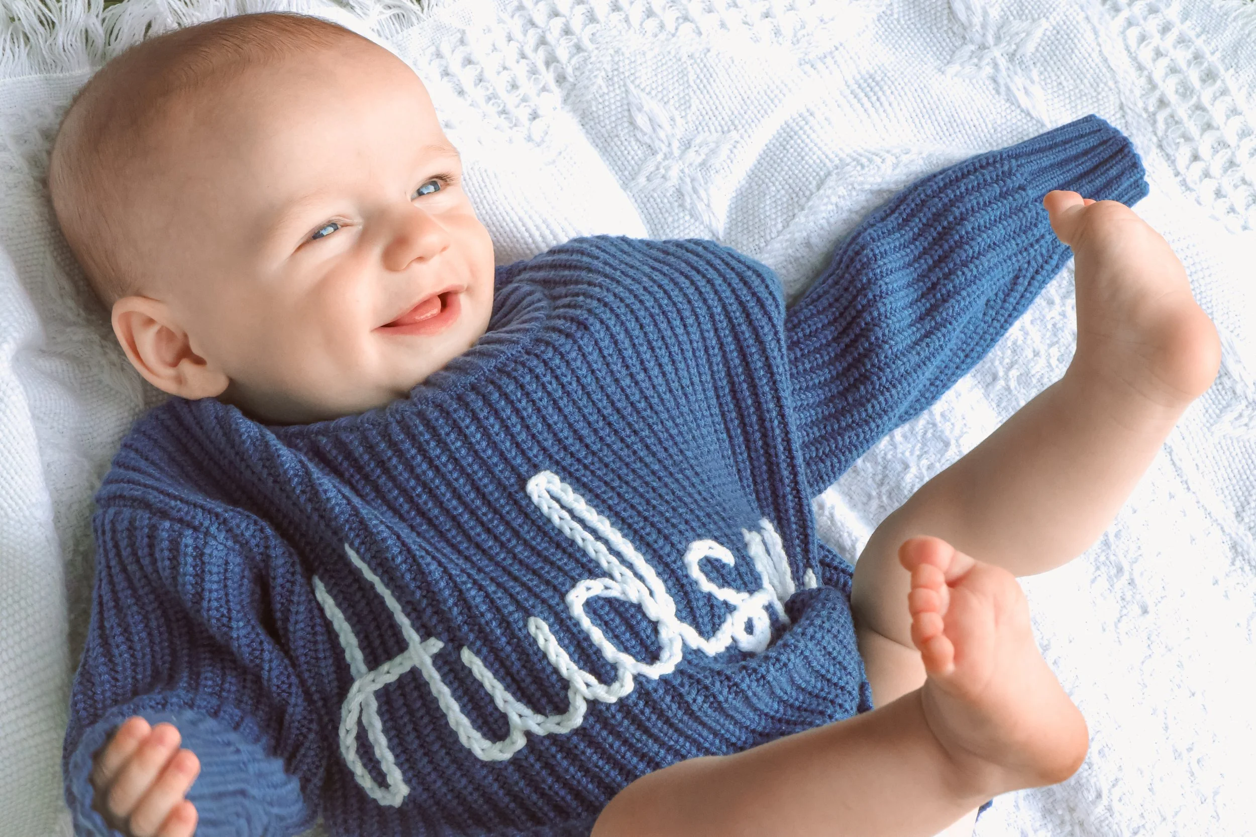 Baby smiling during family photo session in the summer at a park captured by Indianapolis family photographer