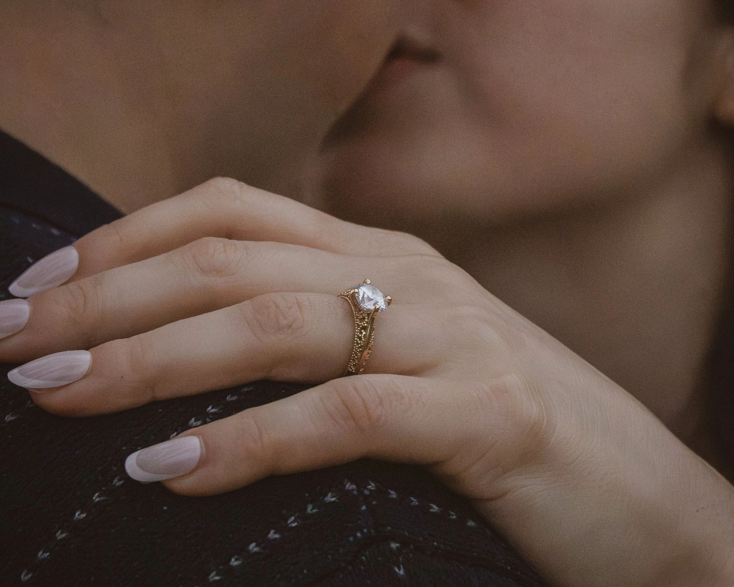 close up photo of woman's engagement ring during engagement photo session in Indianapolis captured by portrait photographer