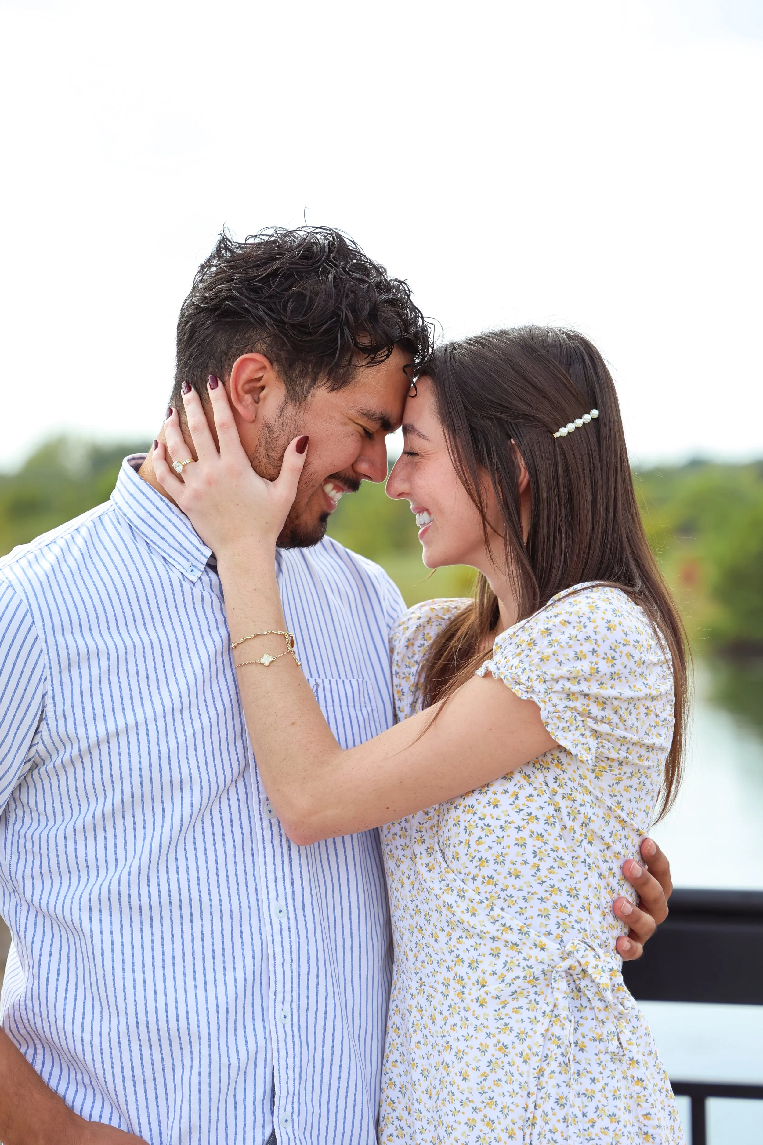 Couple embraces in the summer after proposal photography session in Carmel, Indiana captured by proposal photographer