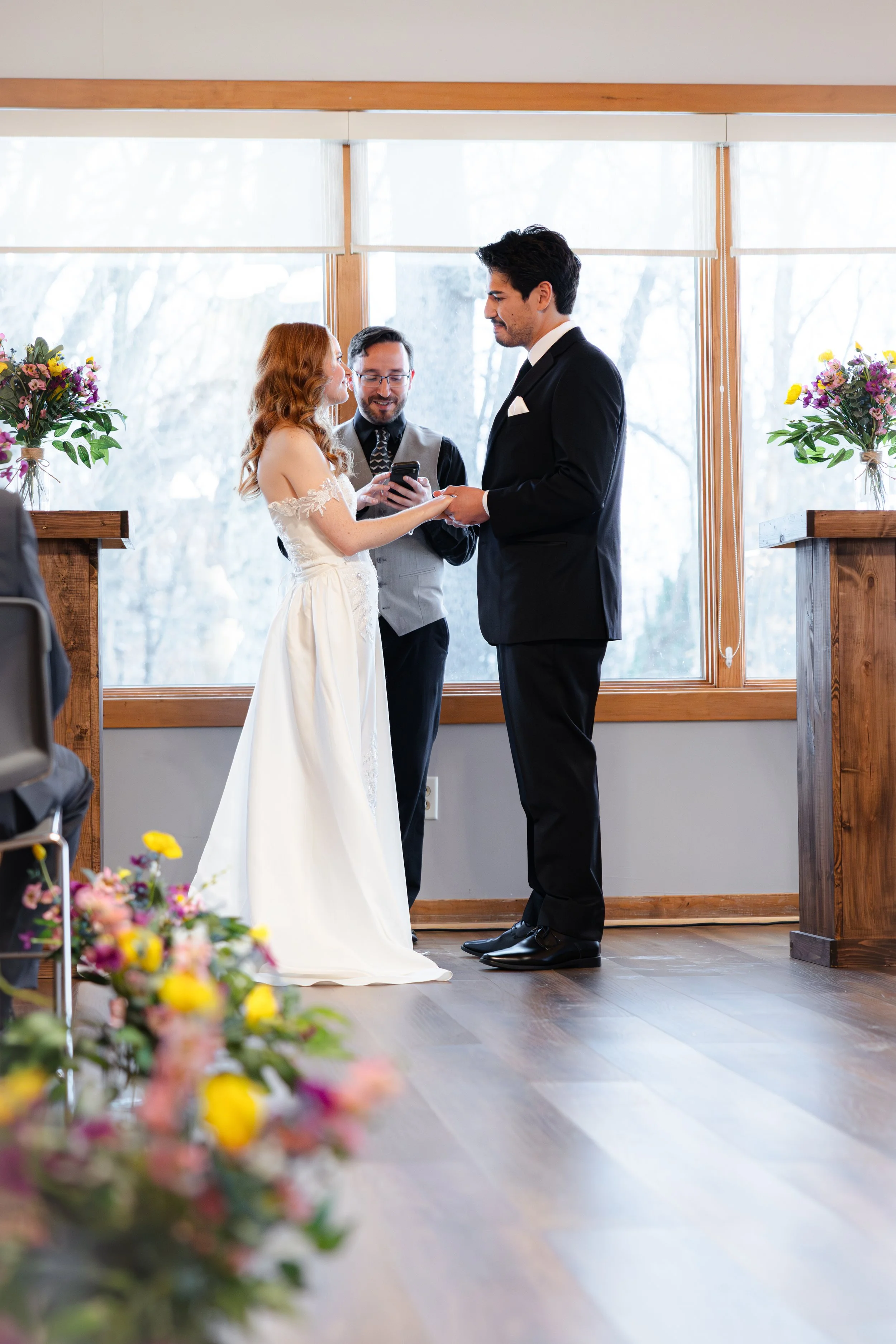 Bride and groom exchanging vows during winter wedding ceremony captured by Indianapolis wedding photographer in Noblesville, Indiana
