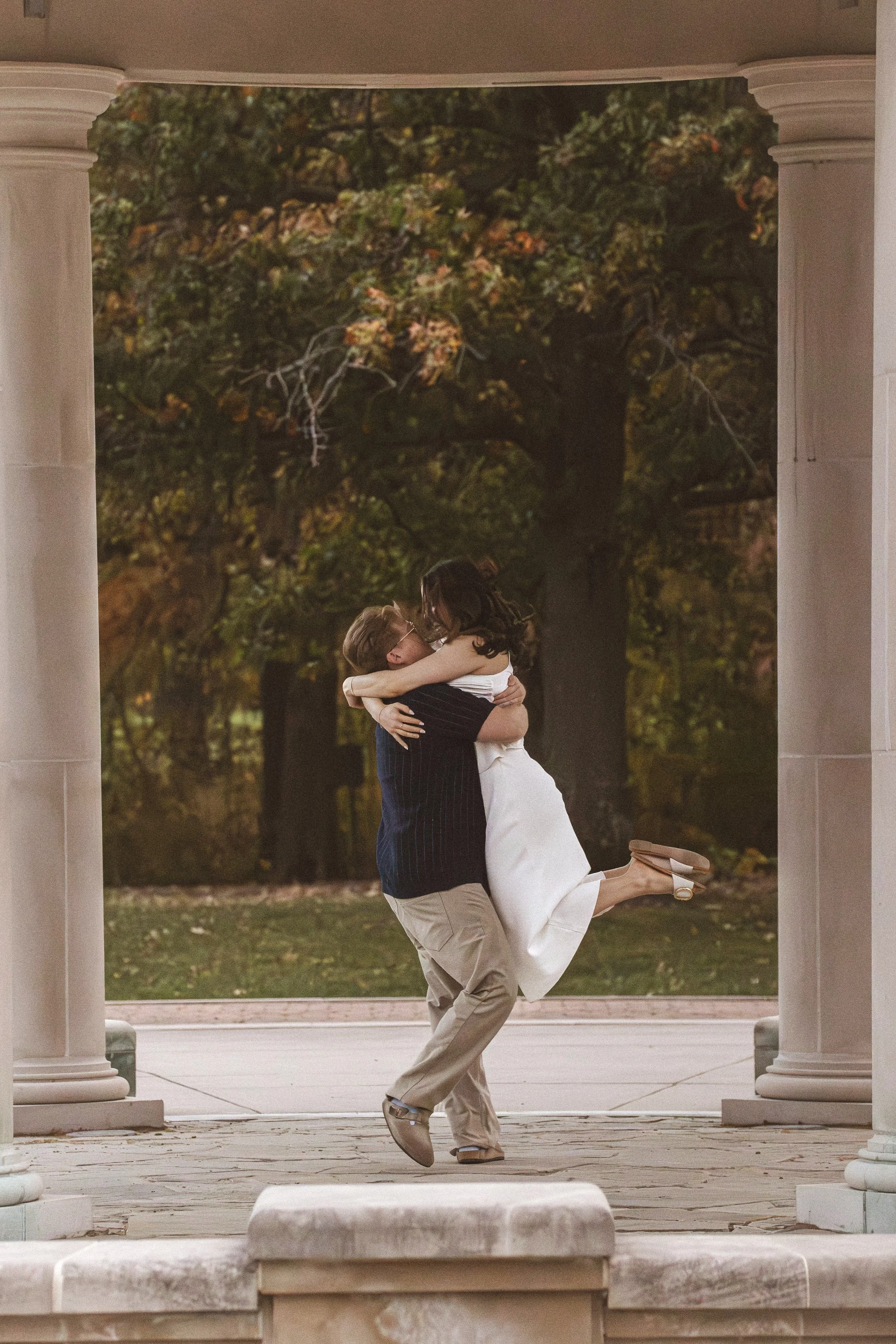 Couple dances in the fall season after engagement photography session in Indianapolis captured by engagement photographer