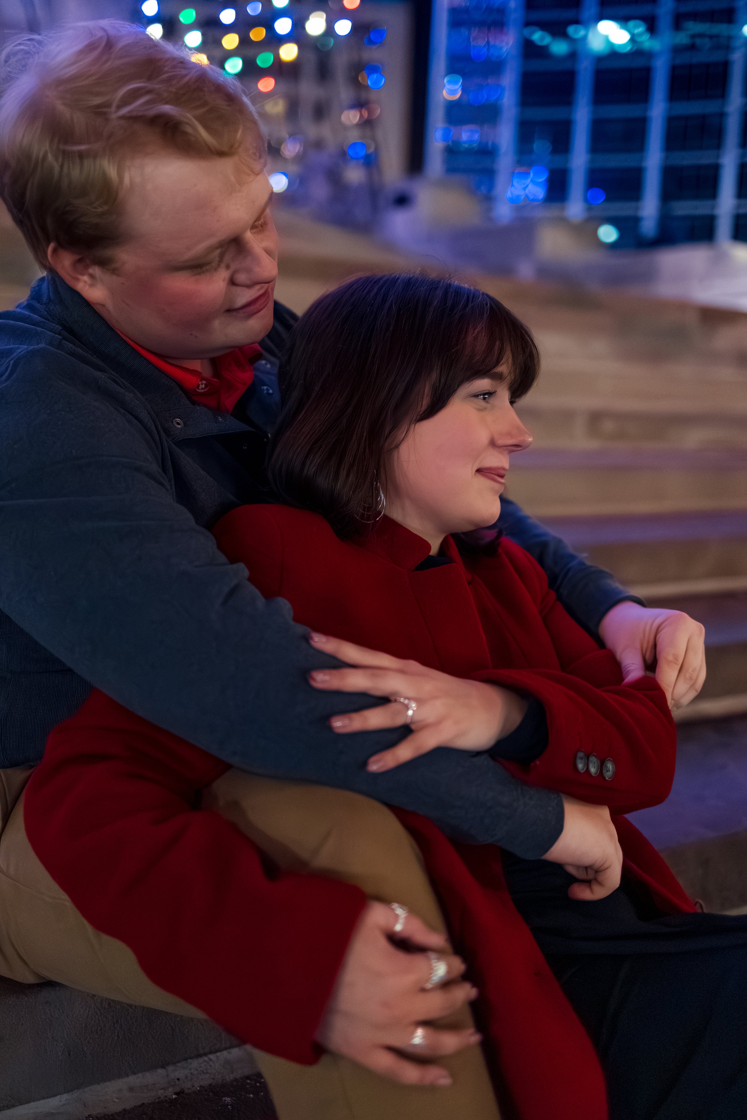 Indianapolis engaged couple embracing during evening proposal captured by engagement photographer