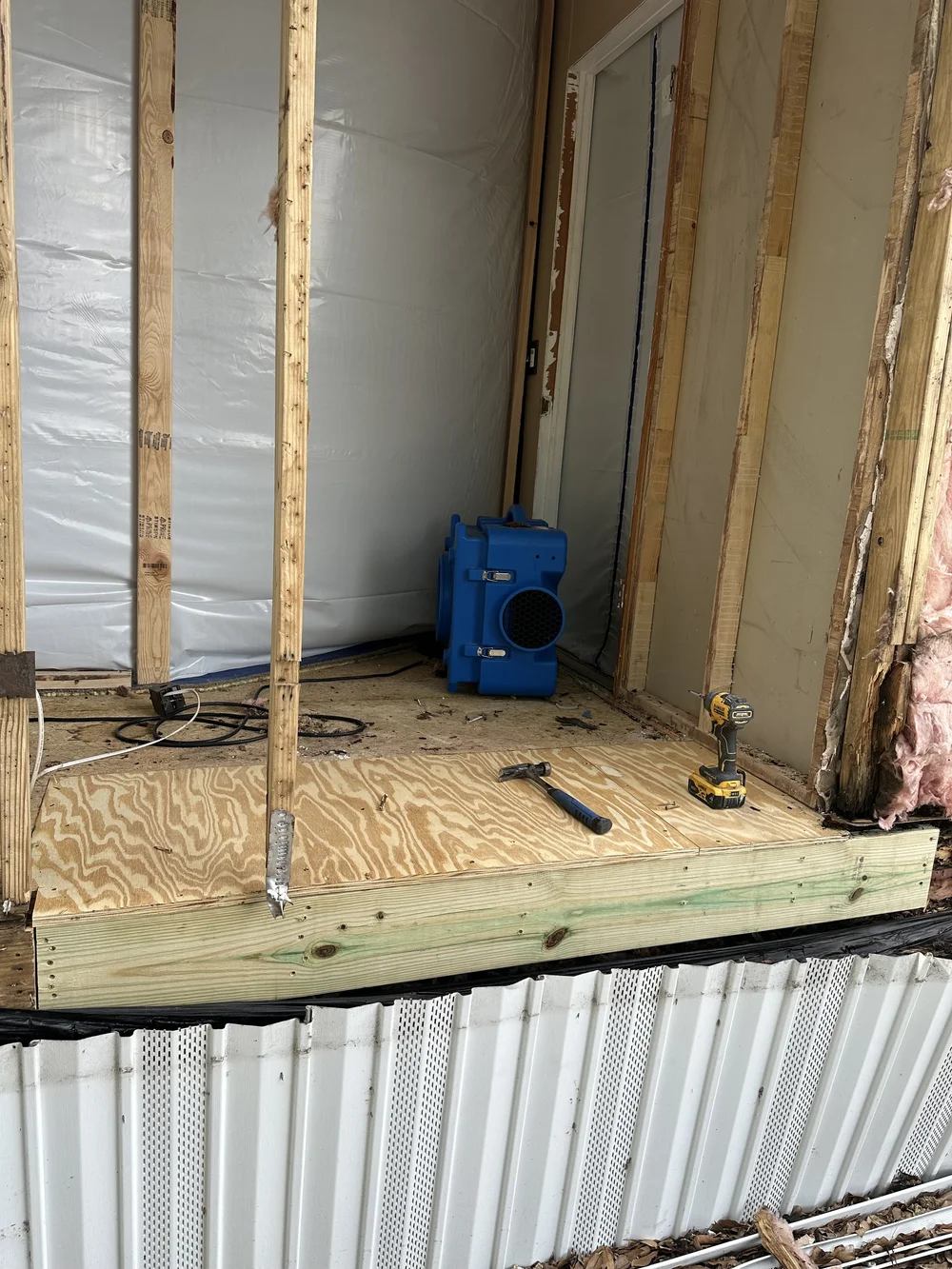 Opened wall and subfloor after water mitigation
