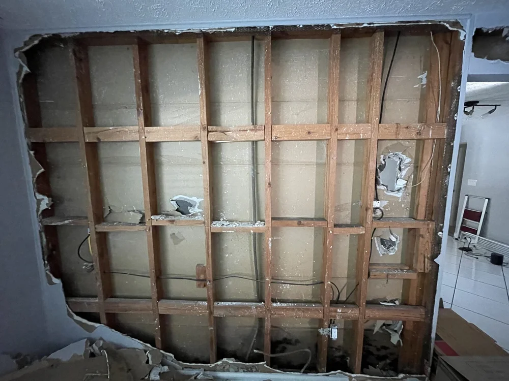 Wall opened to the studs to trace water intrusion