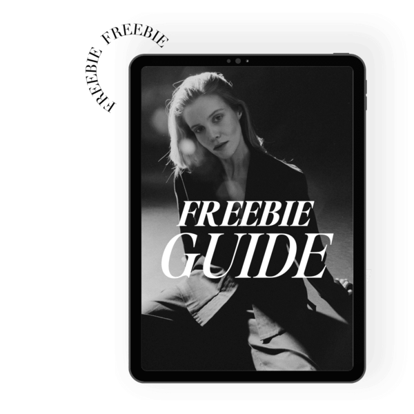 Black and white photo of a woman with light hair, wearing a blazer, sitting and looking at the camera. The text on the image reads "FREEBIE GUIDE" in bold letters.