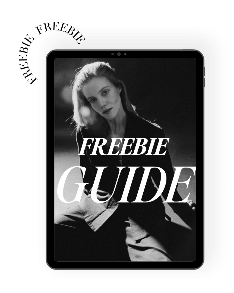 Black and white image of a woman with shoulder-length hair, sitting and looking at the camera, with the words "FREEBIE GUIDE" overlaid in large white font.