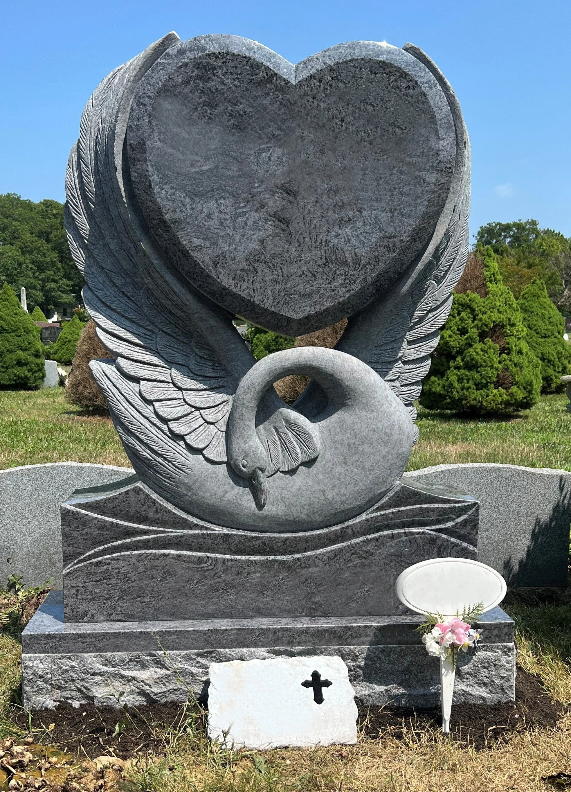 Bahama Blue monument with hand carved swan holding polished heart
