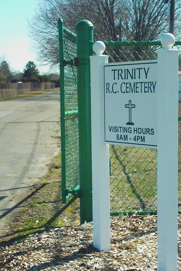 green gate and cemetery sign