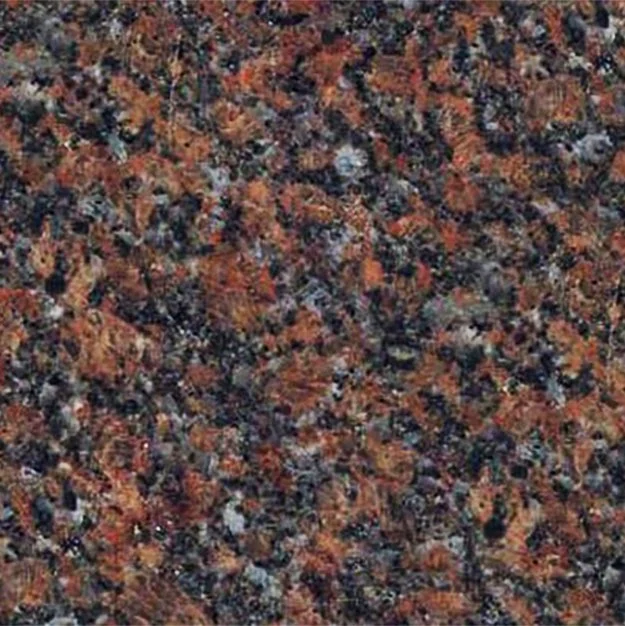 Close-up of a speckled granite countertop with a mix of black, gray, white, and orange-brown minerals.