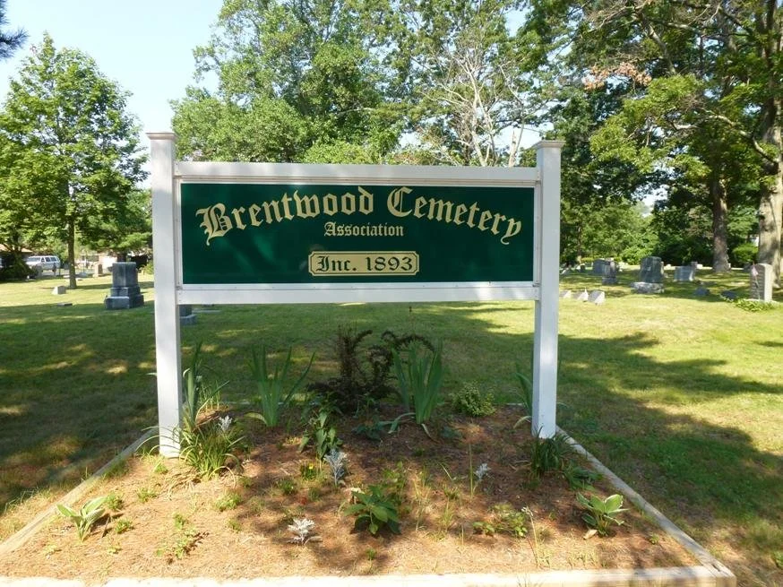 Brentwood Cemetery with white border, green background, and yellow letters