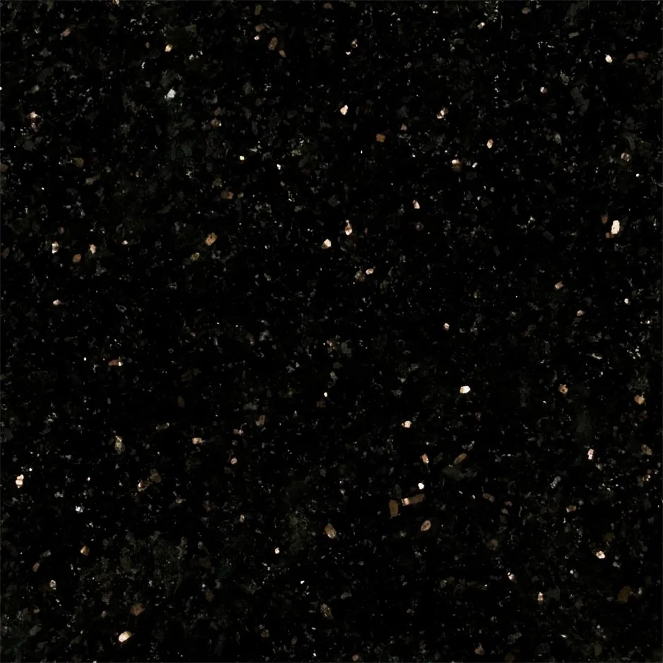 Close-up of black granite countertop with small specks of gold and beige.
