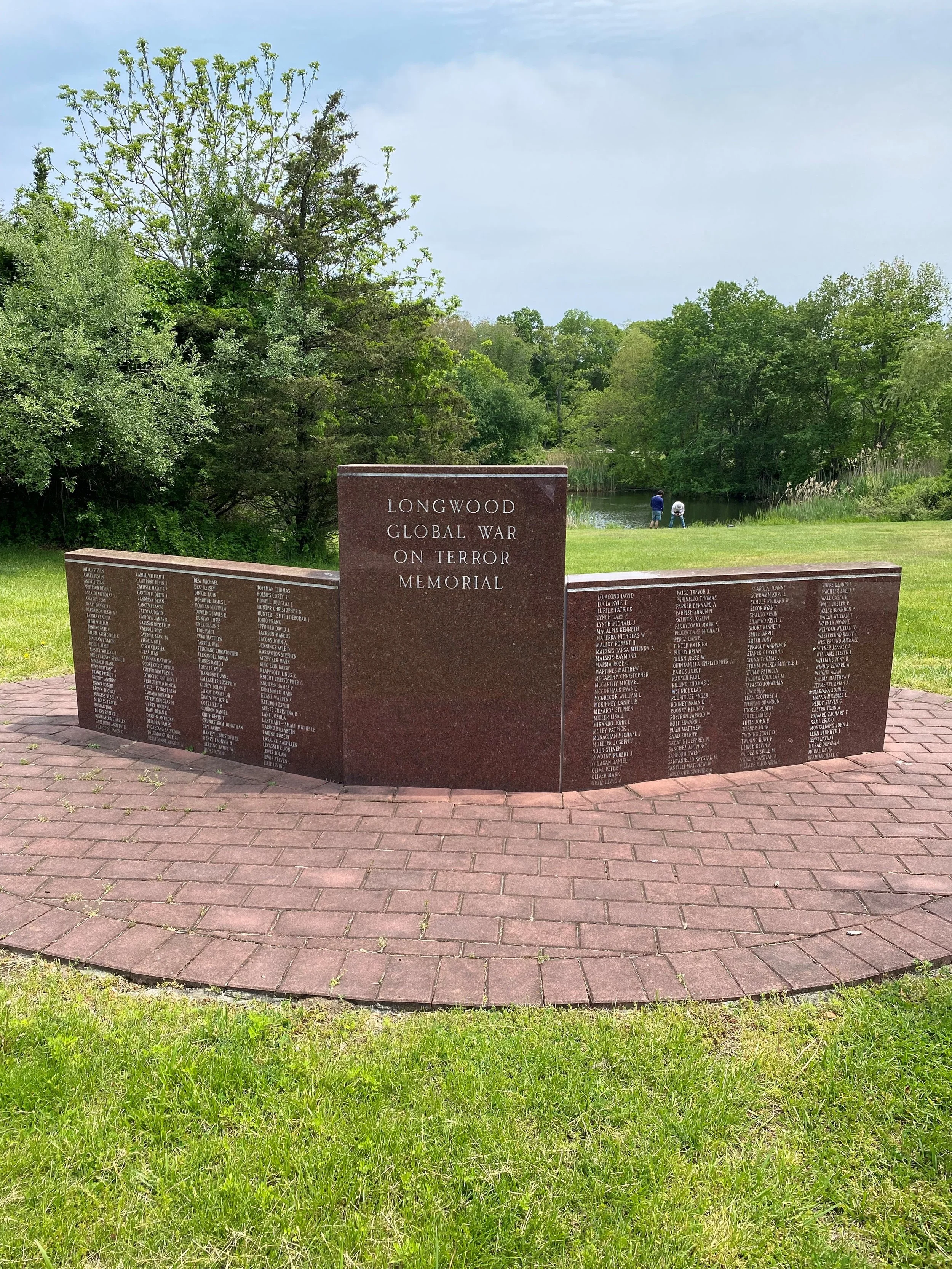 Red granite memorial with brick patio