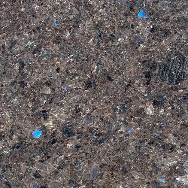 Close-up of a brown and black granite countertop with small blue and gray mineral inclusions.