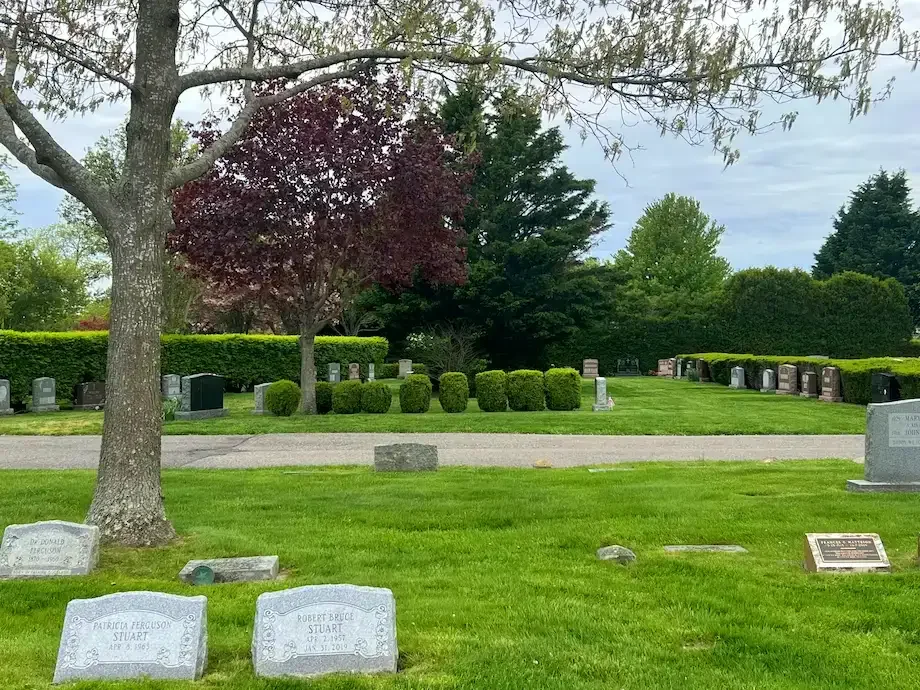 Broad view of cemetery with trees and landscaping