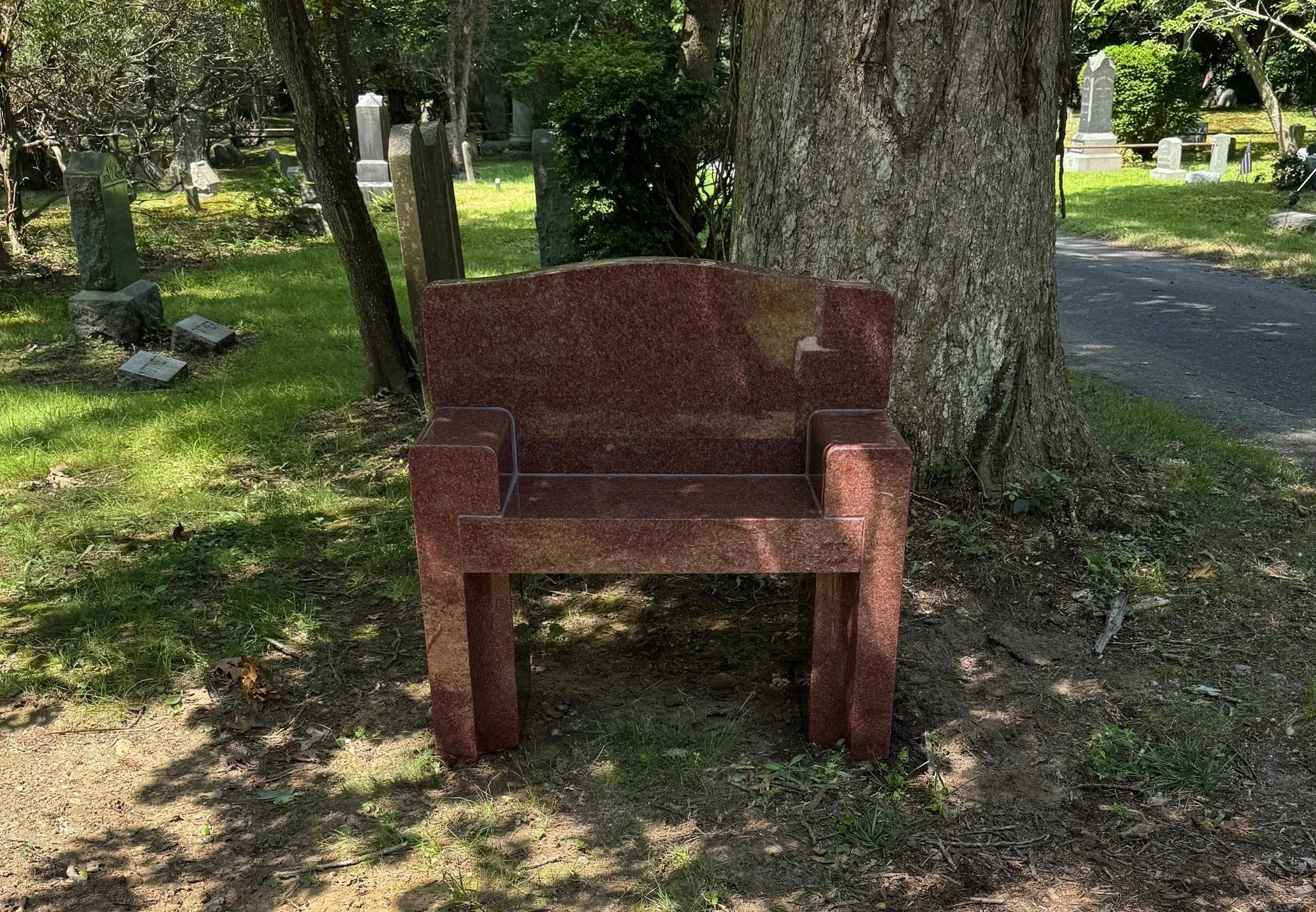 Red bench wtih back in cemetery