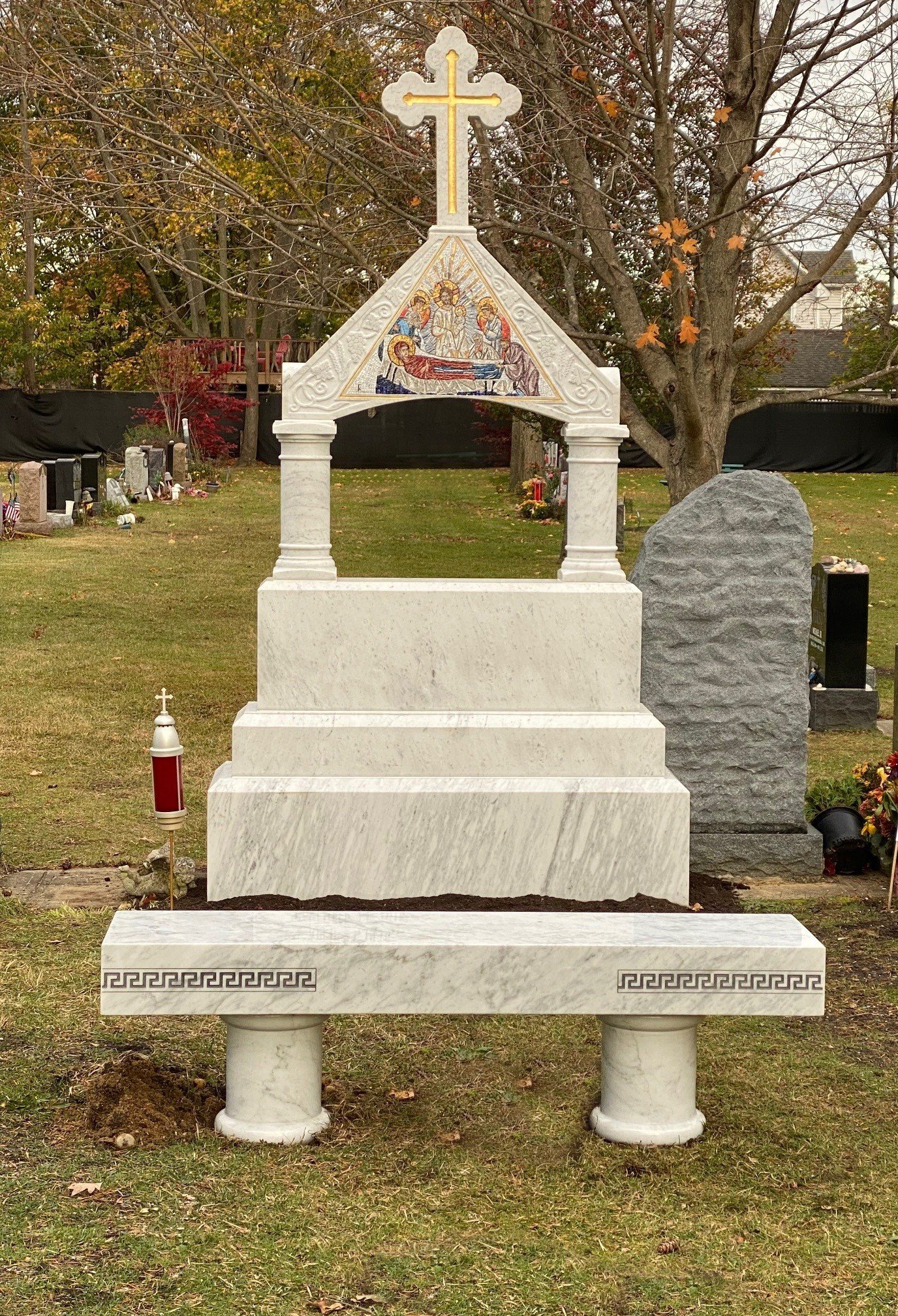 Tiered marble monument with cross and detailed inlay