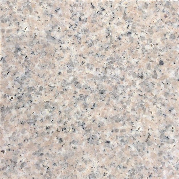 Close-up of a speckled beige and gray granite surface.