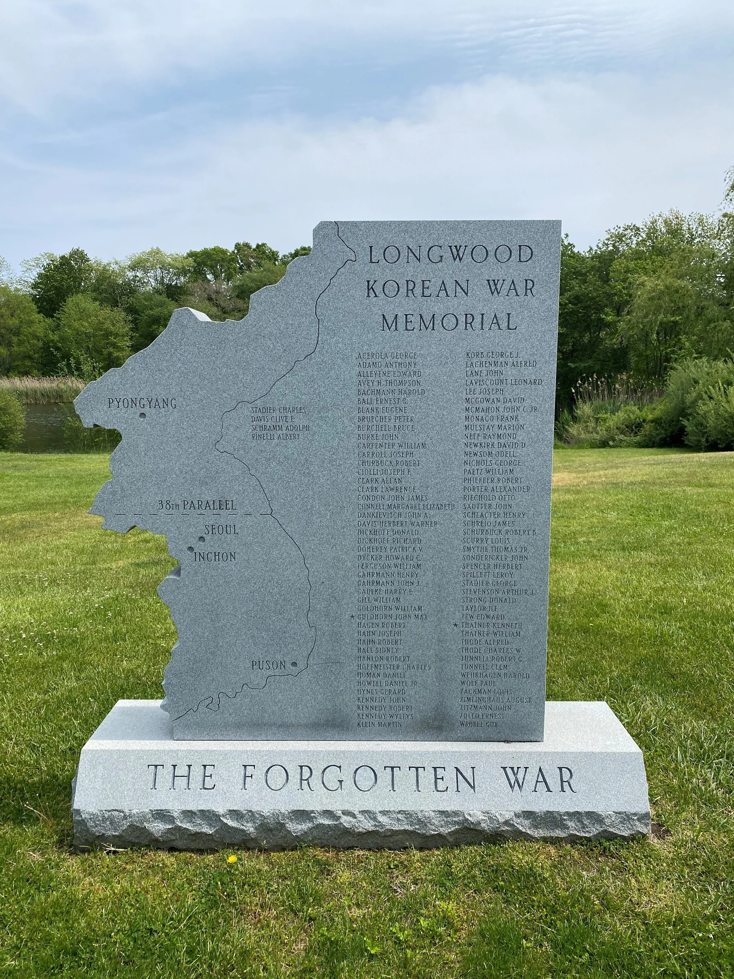 grey granite memorial cut to shape of territory for Korean war