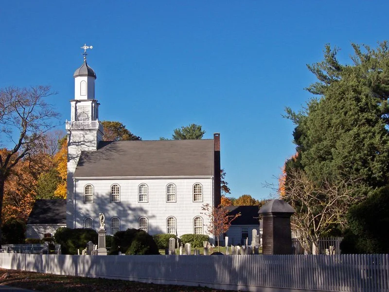 White church with surrounding cemetery