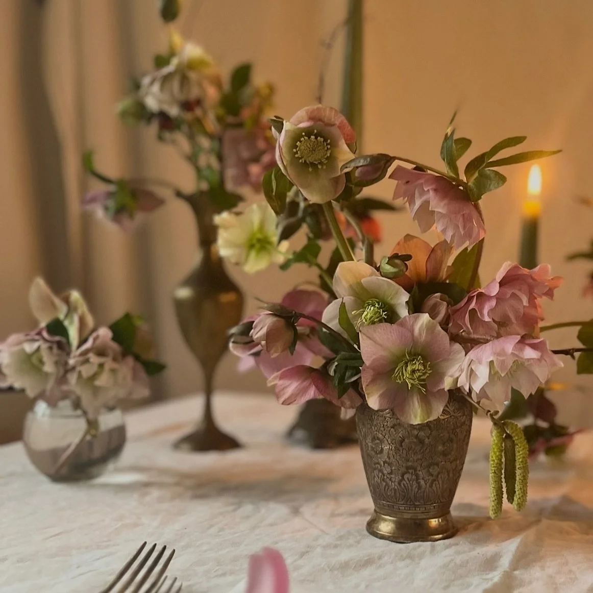 Hellebores again &mdash; I can&rsquo;t seem to stop photographing them.
Brass vessels, candles and early hints of spring.