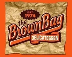 Packaging of Brown Bag Delicatessen with a vintage logo, established in 1974, on a crinkled brown paper background.
