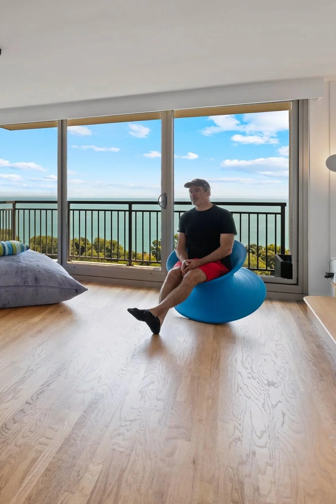 Chicago architect and design-build contractor Patrick Shanahan in a modern condo renovation featuring hardwood floors overlooking Lake Michigan.