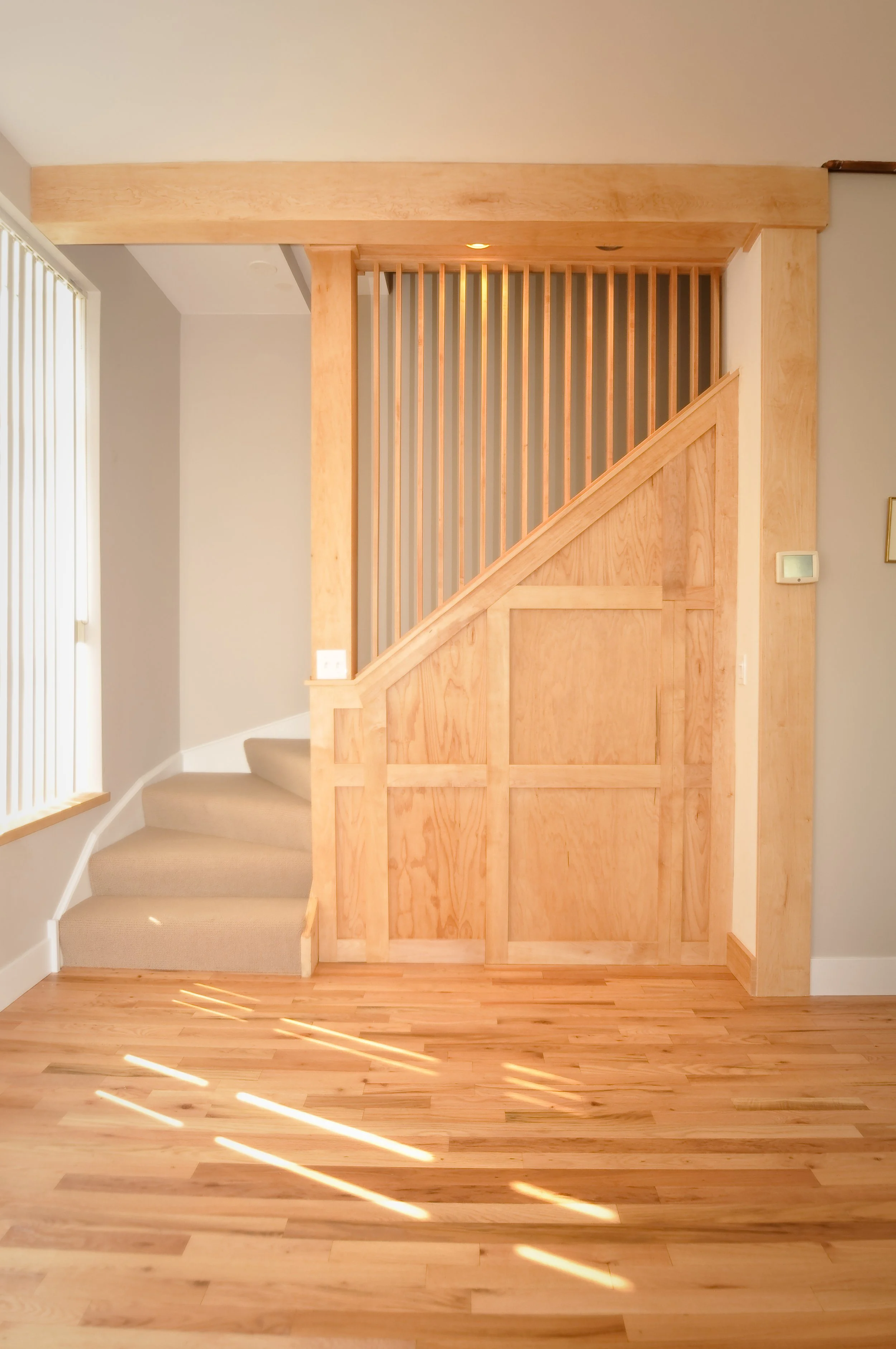 Custom architectural millwork and under-stair storage cabinetry in Albany Park Chicago home renovation.