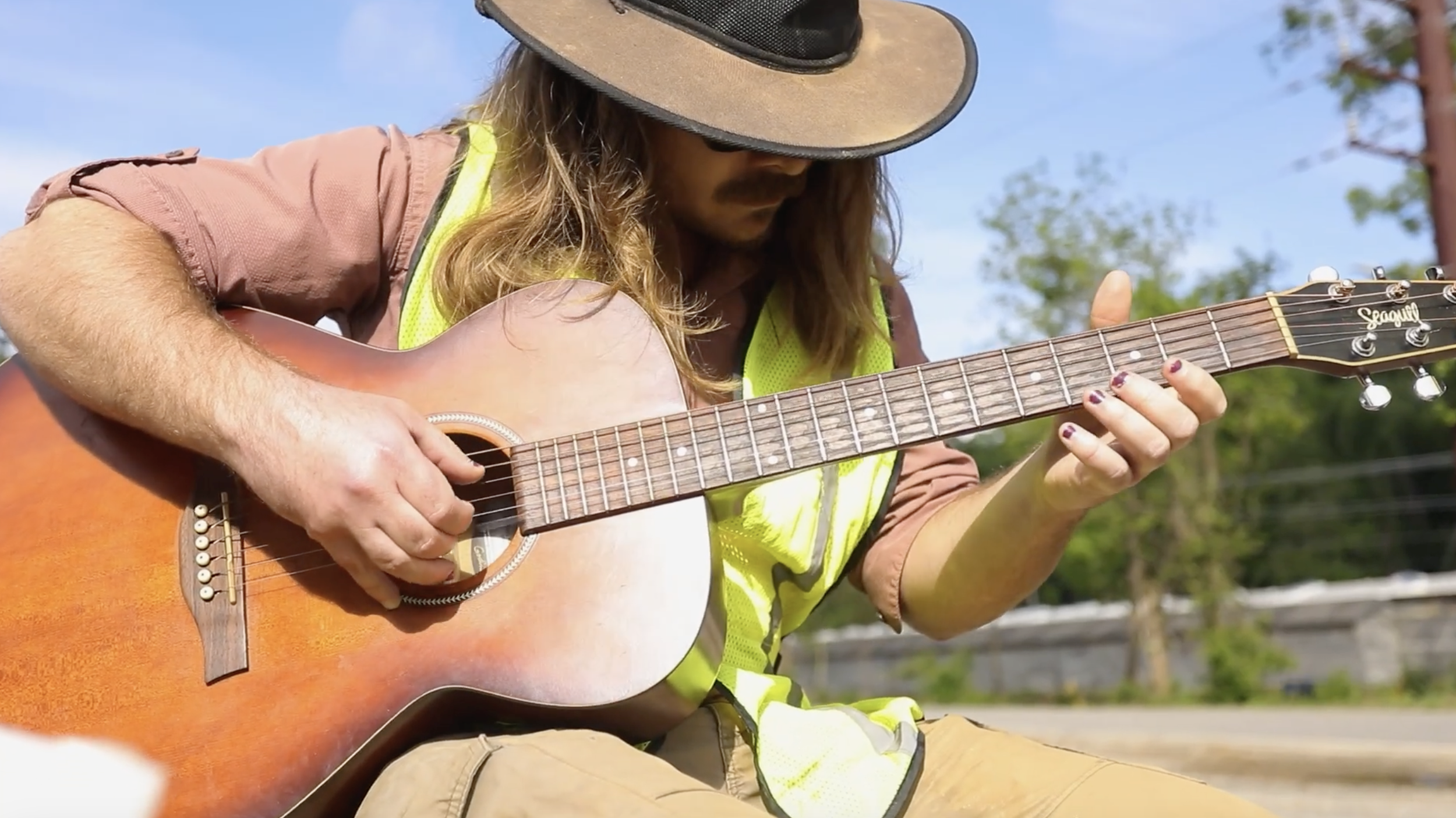 During a lunch break, Chris Hlavay strums his guitar for the cleanup crew.